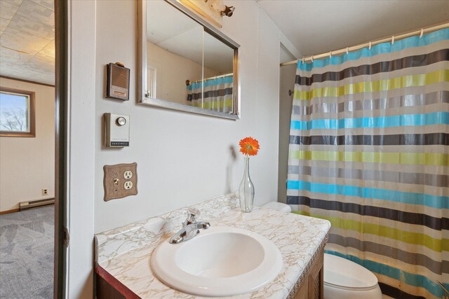bathroom featuring toilet, vanity, and a shower with curtain