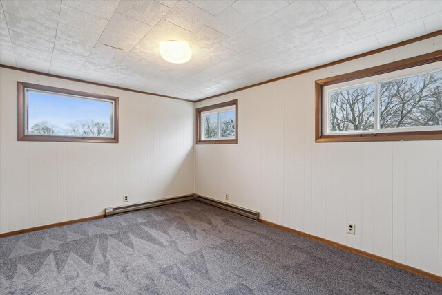 spare room with baseboards, carpet floors, ornamental molding, and a baseboard radiator