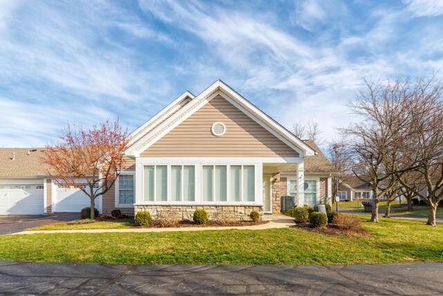 1998 Brighton Ln, Portage, MI 49024 - view of front facade featuring stone siding, aphalt driveway, an attached garage, and a front lawn