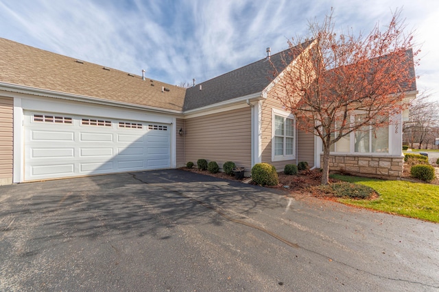 1998 Brighton Ln, Portage, MI 49024 - view of front facade with a shingled roof, aphalt driveway, and an attached garage