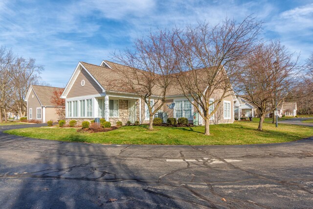 1998 Brighton Ln, Portage, MI 49024 - view of front of property featuring stone siding and a front lawn