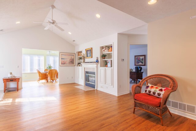 1998 Brighton Ln, Portage, MI 49024 - sitting room with visible vents, baseboards, a fireplace, a ceiling fan, and light wood-type flooring