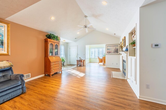 1998 Brighton Ln, Portage, MI 49024 - living area with a fireplace with flush hearth, visible vents, light wood finished floors, baseboards, and ceiling fan