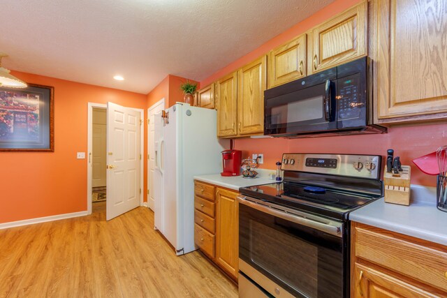1998 Brighton Ln, Portage, MI 49024 - kitchen featuring black microwave, stainless steel range with electric cooktop, light countertops, and light wood-style floors