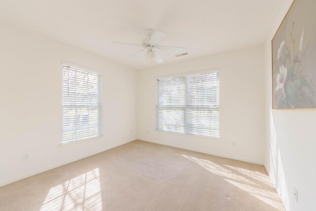 1998 Brighton Ln, Portage, MI 49024 - carpeted spare room with visible vents and a ceiling fan