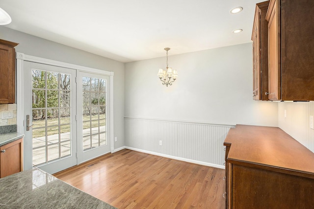 1625 Arlington Blvd, Ann Arbor, MI 48104 - unfurnished dining area featuring light wood finished floors, a chandelier, recessed lighting, and a wainscoted wall