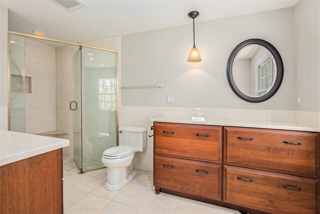 1625 Arlington Blvd, Ann Arbor, MI 48104 - full bath with vanity, tile walls, tile patterned flooring, a stall shower, and a wainscoted wall