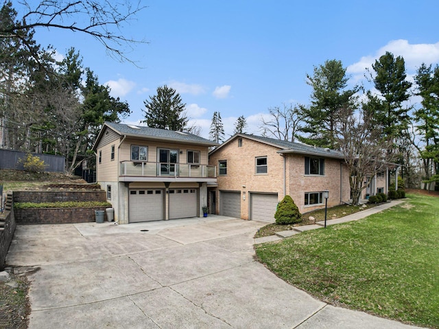 view of front of property with a garage, a front yard, and driveway