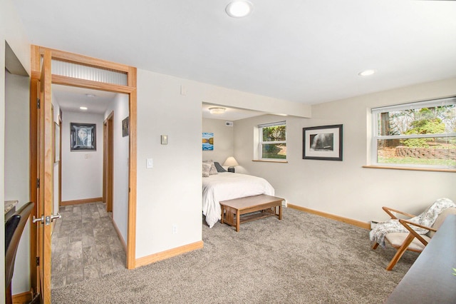 bedroom featuring baseboards, multiple windows, and recessed lighting