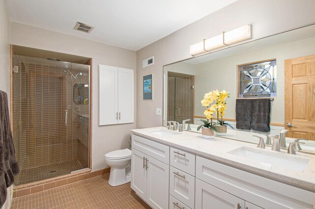 bathroom with tile patterned flooring, visible vents, a sink, and a stall shower