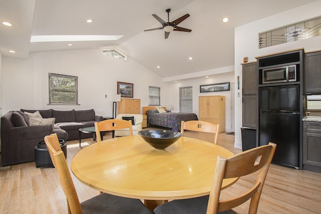 dining space featuring light wood-style flooring, high vaulted ceiling, a ceiling fan, and recessed lighting