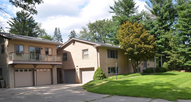 view of front facade featuring a garage, a front yard, concrete driveway, and brick siding