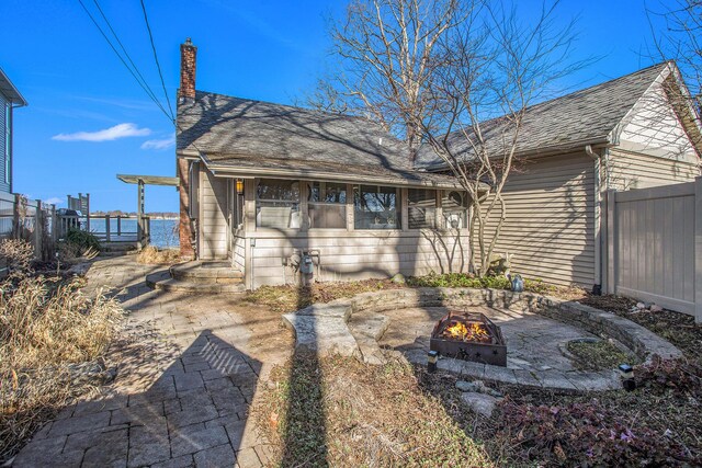 274 Hawley Center Dr, Coldwater, MI 49036 - back of property featuring a fire pit, fence, and a chimney