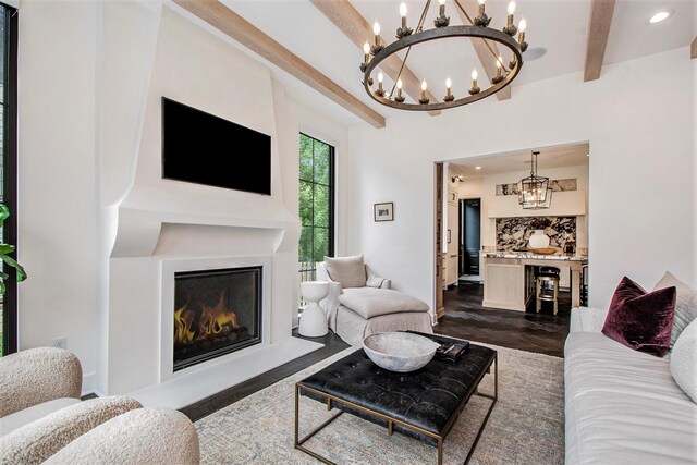 557 Greenwood Ave SE, East Grand Rapids, MI 49506 - living area with a warm lit fireplace, a notable chandelier, beam ceiling, and recessed lighting