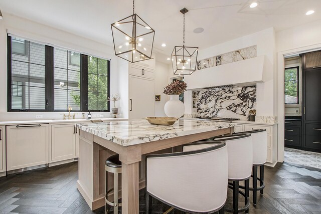 557 Greenwood Ave SE, East Grand Rapids, MI 49506 - kitchen featuring white cabinets, a chandelier, recessed lighting, a kitchen island, and tasteful backsplash