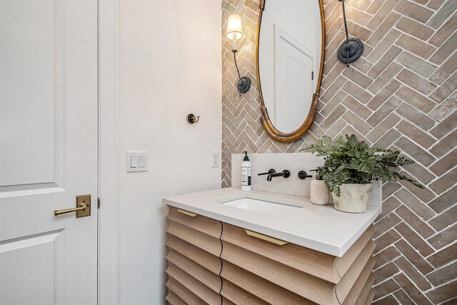 557 Greenwood Ave SE, East Grand Rapids, MI 49506 - bathroom featuring decorative backsplash and vanity