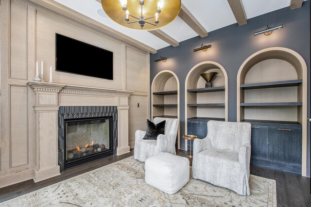 557 Greenwood Ave SE, East Grand Rapids, MI 49506 - living area with built in features, wood finished floors, an inviting chandelier, and beamed ceiling