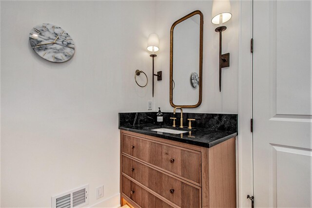 557 Greenwood Ave SE, East Grand Rapids, MI 49506 - bathroom featuring visible vents and vanity