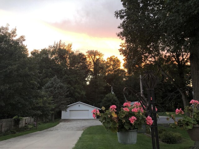 101 Lakeside Dr, Quincy, MI 49082 - view of front of property with an outdoor structure, a front yard, a garage, and fence