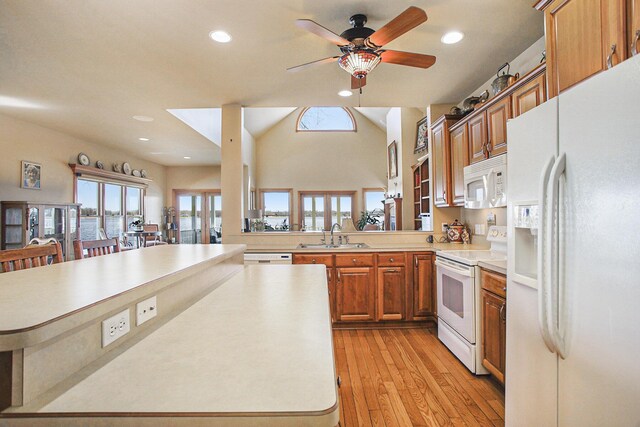 101 Lakeside Dr, Quincy, MI 49082 - kitchen featuring light countertops, a sink, brown cabinets, white appliances, and light wood-style floors