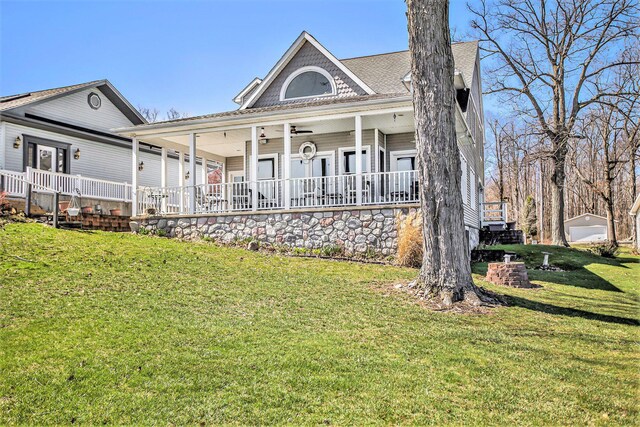 101 Lakeside Dr, Quincy, MI 49082 - rear view of house with a porch, roof with shingles, and a lawn