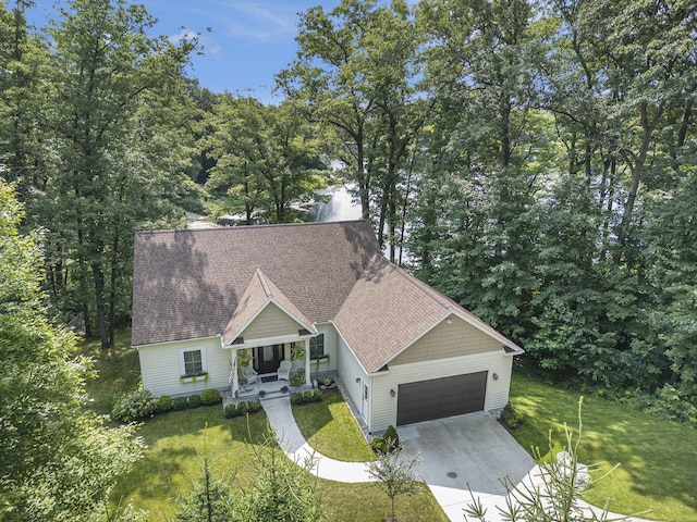 5091 E High Tower Lake Rd, Hesperia, MI 49421 - view of front facade with an attached garage, a front lawn, driveway, a shingled roof, and a porch