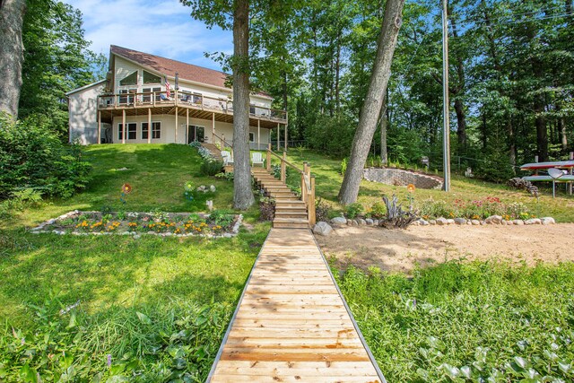 5091 E High Tower Lake Rd, Hesperia, MI 49421 - rear view of property with a yard, stairs, and a wooden deck