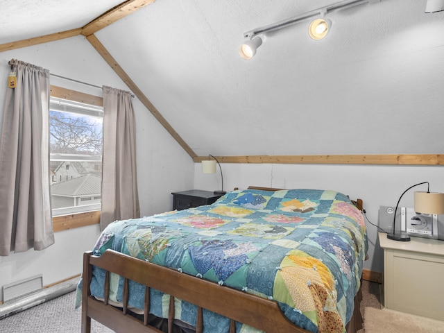 817 E Loomis St, Ludington, MI 49431 - bedroom featuring lofted ceiling with beams, carpet floors, and a textured ceiling