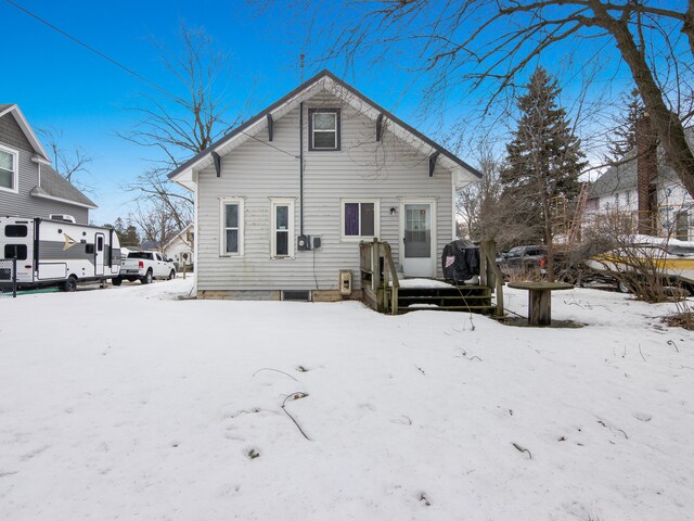 817 E Loomis St, Ludington, MI 49431 - snow covered rear of property with a wooden deck