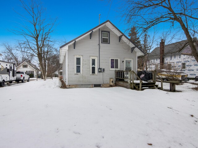 817 E Loomis St, Ludington, MI 49431 - snow covered back of property with a wooden deck