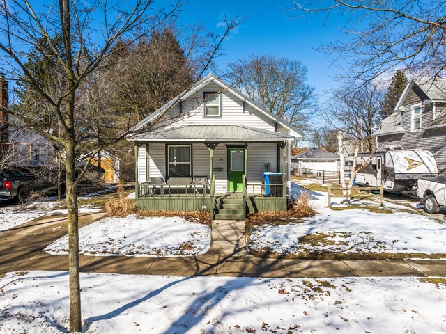 817 E Loomis St, Ludington, MI 49431 - bungalow with metal roof and a porch