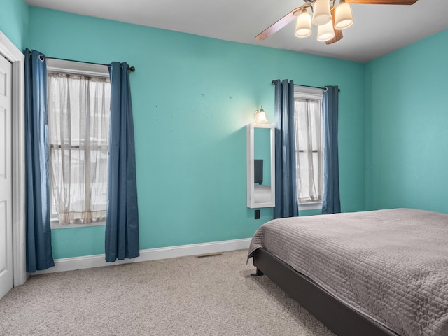 817 E Loomis St, Ludington, MI 49431 - carpeted bedroom with baseboards, visible vents, and ceiling fan