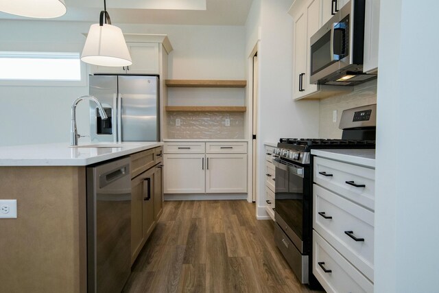 6447 Railbridge Ct SE Unit 26, Caledonia, MI 49316 - kitchen featuring light countertops, stainless steel appliances, decorative light fixtures, decorative backsplash, and dark wood-type flooring
