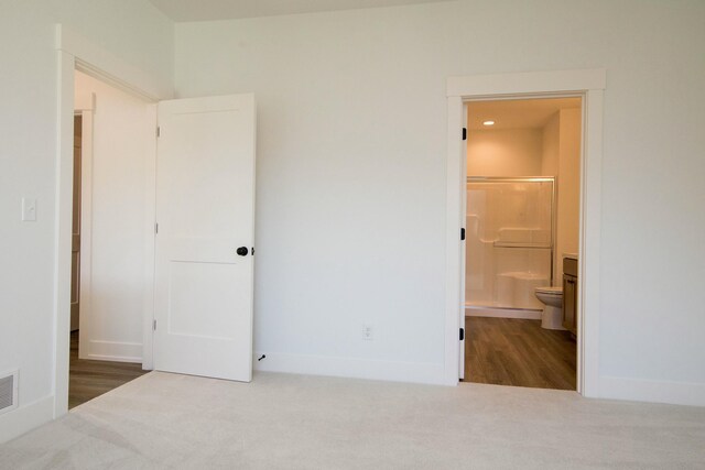6447 Railbridge Ct SE Unit 26, Caledonia, MI 49316 - unfurnished bedroom featuring connected bathroom, baseboards, visible vents, and carpet
