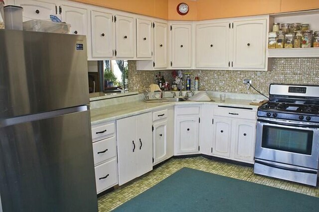 25544 Gage St, Dowagiac, MI 49047 - kitchen featuring appliances with stainless steel finishes, white cabinets, light countertops, and decorative backsplash