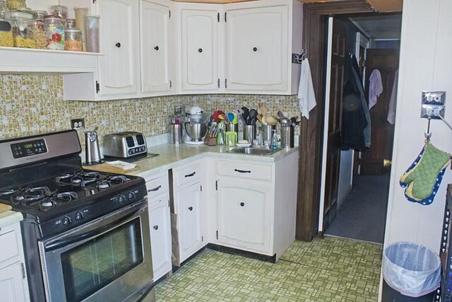 25544 Gage St, Dowagiac, MI 49047 - kitchen featuring stainless steel gas stove, white cabinets, and light countertops