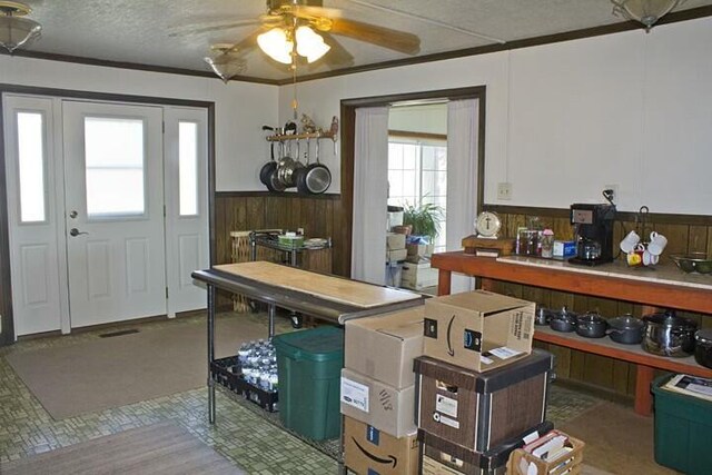 25544 Gage St, Dowagiac, MI 49047 - office featuring ceiling fan, a wainscoted wall, wooden walls, crown molding, and a textured ceiling