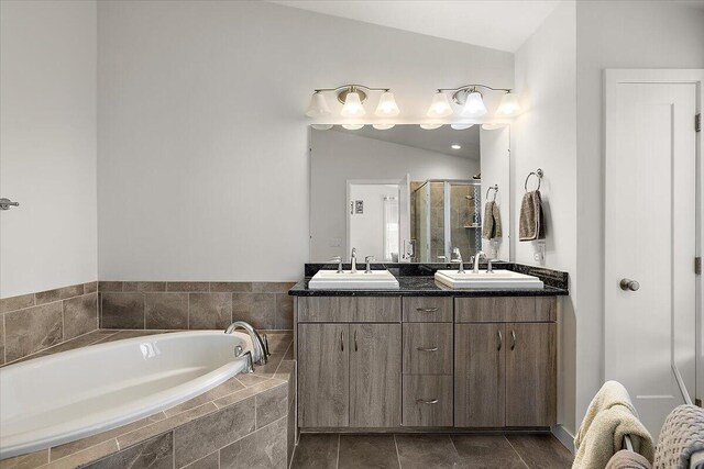 2824 Ridington Rd, Ann Arbor, MI 48105 - bathroom with a sink, double vanity, lofted ceiling, a bath, and a stall shower