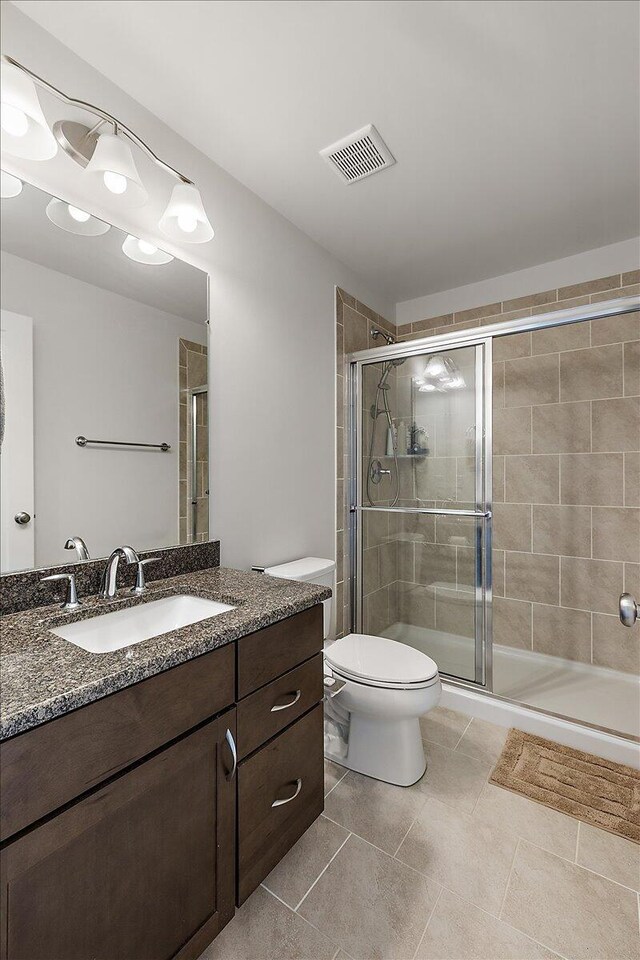 2824 Ridington Rd, Ann Arbor, MI 48105 - bathroom featuring tile patterned flooring, vanity, toilet, a shower stall, and visible vents