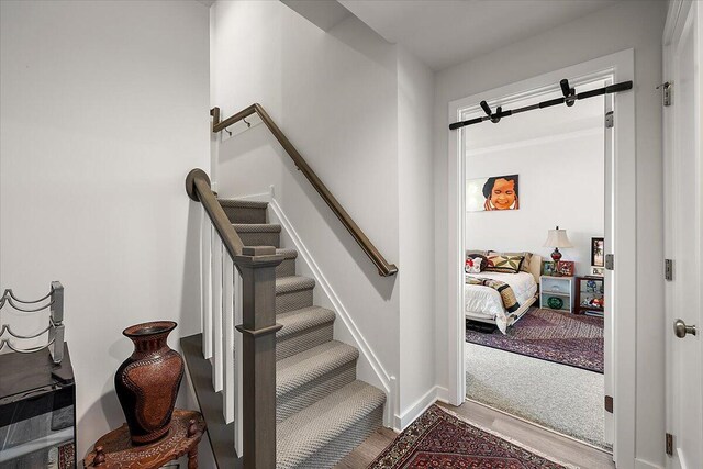 2824 Ridington Rd, Ann Arbor, MI 48105 - stairs featuring baseboards and wood finished floors