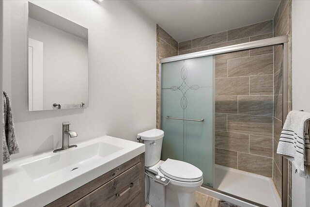 2824 Ridington Rd, Ann Arbor, MI 48105 - bathroom featuring vanity, a stall shower, and toilet
