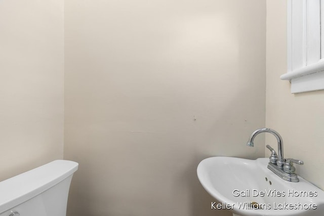 bathroom featuring toilet and a sink