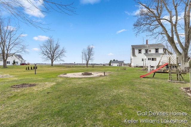 view of yard featuring an outdoor fire pit and stairs