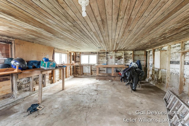 misc room with wood ceiling, concrete floors, and a workshop area