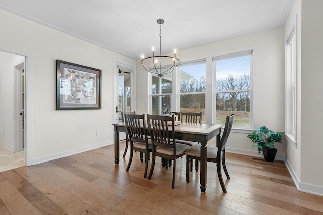 8114 Turning Stone, Kalamazoo, MI 49009 - dining room featuring a notable chandelier, baseboards, and light wood-type flooring