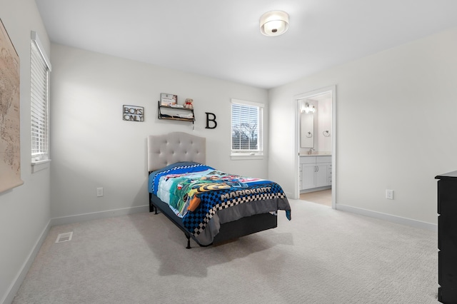 8114 Turning Stone, Kalamazoo, MI 49009 - bedroom with ensuite bathroom, light colored carpet, visible vents, and baseboards