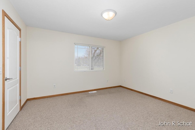 7588 Rivendell Dr SE, Grand Rapids, MI 49508 - unfurnished bedroom with light colored carpet, visible vents, and baseboards