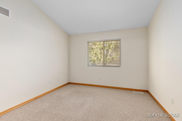 7588 Rivendell Dr SE, Grand Rapids, MI 49508 - spare room with carpet, baseboards, and visible vents