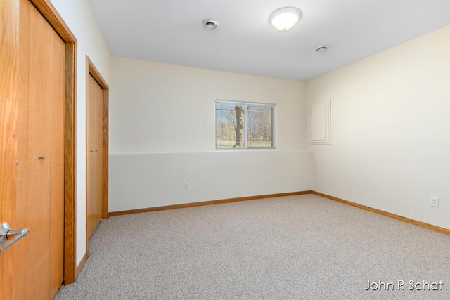 7588 Rivendell Dr SE, Grand Rapids, MI 49508 - unfurnished bedroom with baseboards, a closet, and carpet flooring