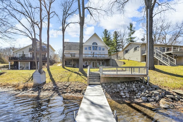 11262 Lemott Cir, Jerome, MI 49249 - rear view of house with a lawn, a deck with water view, and stairs